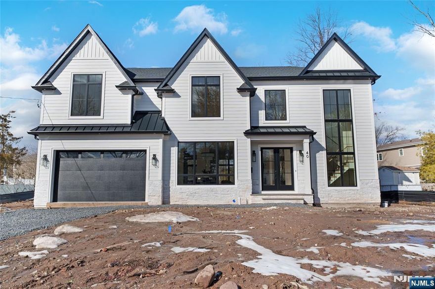 Welcome to 40 Godfrey Terrace, a distinguished new construction home in the heart of Glen Rock Boro, NJ. This exceptional property offers six spacious bedrooms and five and a half well-appointed bathrooms, designed to accommodate modern living with style and comfort. The home boasts a fully finished basement, perfect for additional living space or entertainment. The gourmet kitchen is equipped with new, state-of-the-art appliances, ideal for culinary enthusiasts. The open floor plan allows for an abundance of natural light, enhancing the home's inviting atmosphere. The living area features a cozy fireplace, providing warmth and ambiance during cooler months. The primary bedroom is a private retreat, complete with a luxurious ensuite bathroom and a generous walk-in closet. Additional amenities include a dedicated movie theater and a gym, catering to all your entertainment and fitness needs. A two-car garage offers convenience and ample storage space. The property is situated in a desirable neighborhood, known for its community spirit and excellent schools. This home is a rare find, combining modern amenities with a prime location. Experience the best of Glen Rock living at 40 Godfrey Terrace. Schedule your private viewing today.