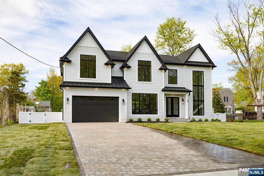 Welcome to 40 Godfrey Terrace, a distinguished new construction home in the heart of Glen Rock Boro, NJ. This exceptional property offers six spacious bedrooms and five and a half well-appointed bathrooms, designed to accommodate modern living with style and comfort. The home boasts a fully finished basement, perfect for additional living space or entertainment. The gourmet kitchen is equipped with new, state-of-the-art appliances, ideal for culinary enthusiasts. The open floor plan allows for an abundance of natural light, enhancing the home's inviting atmosphere. The living area features a cozy fireplace, providing warmth and ambiance during cooler months. The primary bedroom is a private retreat, complete with a luxurious ensuite bathroom and a generous walk-in closet. Additional amenities include a dedicated movie theater and a gym, catering to all your entertainment and fitness needs. A two-car garage offers convenience and ample storage space. The property is situated in a desirable neighborhood, known for its community spirit and excellent schools. This home is a rare find, combining modern amenities with a prime location. Experience the best of Glen Rock living at 40 Godfrey Terrace. Schedule your private viewing today.