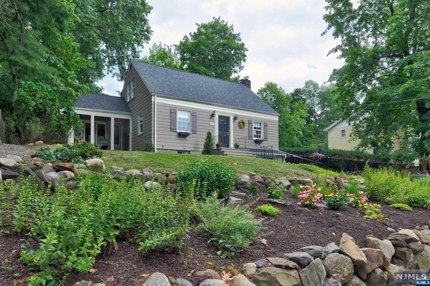 Welcome to this beautifully renovated home in the sought-after Packanack Lake community. This inviting two-story residence offers three spacious bedrooms, two modern bathrooms, and central A.C., all set on a generous quarter-acre lot. The cozy living room features a wood-burning fireplace, and the adjacent dining room is ideal for entertaining. A bright family room with a wall of windows offers a sunny retreat. The kitchen boasts sleek stainless steel appliances. A newly updated bathroom with a frameless glass shower adds luxury. Upstairs, the primary bedroom impresses with a cathedral ceiling, while two additional bedrooms provide comfort. A renovated full bath completes the upper level. Outside, enjoy the landscaped backyard with rock gardens, a scenic deck, and a charming front porch. Packanack Lake offers swimming, fishing, boating, tennis, and golf. With NYC transit nearby, this home blends lakeside living with urban convenience.