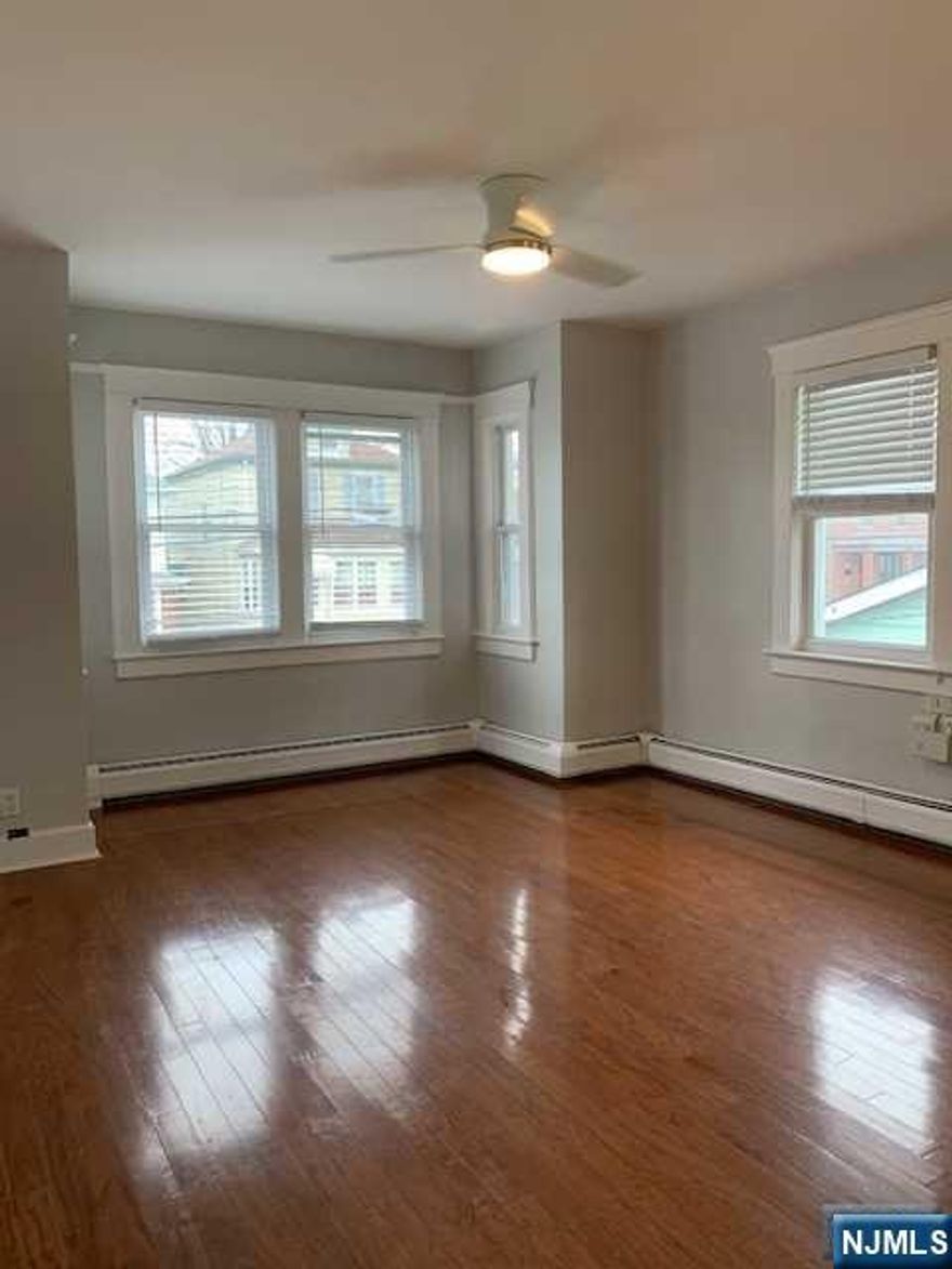 2 bedroom + Den/3rd bedroom; bright & sunny unit located on 2nd floor; nice size living room & dining room combo; eat-in-kitchen with newer stainless steel refrigerator; newer hardwood floors in living room and dining room. updated bathroom; new w/w carpet in bedrooms; tiles in kitchen and hallways; access to large storage space in attic; washer/dryer on premises; access to yard and use of seasonal patio set on premises; walking distance to downtown shops, schools and to public transportation for easy commute; driveway parking available for additional fee; landlord is licensed new jersey agent