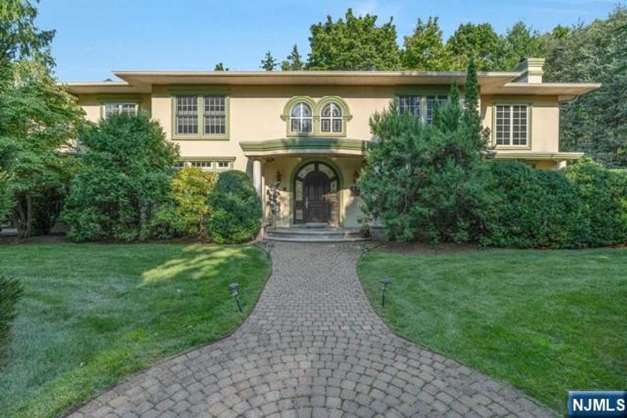 Custom built colonial set on approximately one half acre in the Strand section of Teaneck. Entry has sweeping staircase, elegant Living Room with Fireplace, grand Formal Dining Room with glass doors opening to patio, true Butler's pantry and gourmet kitchen including 3 dishwashers, Garland stove, large, windowed breakfast room, impressive office/library with custom bookcases, ensuite guest accommodations with private entranceway. 10 foot ceilings and mostly hardwood on first floor Second floor has Master Suite with private gym, laundry facilities, 2 ensuite bedrooms with full baths, 2 additional bedrooms, full bath. High ceilinged basement is a wonderland for kids or serious entertainment, Full Bath. Close to multiple houses of worship.