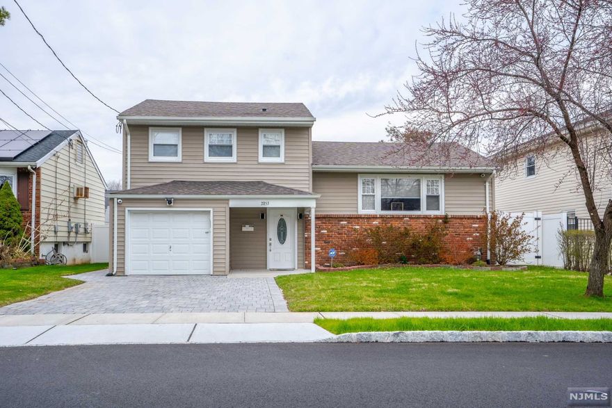 Striking beautiful Bi- Level home featuring 4 bedrooms, 2.5 full bathrooms, central air and heat, large backyard with 2 car driveway, and large attached garage. Upon entering, you will appreciate utilizing the front entry living. Afterwards, you will experience the ambiance of crown molding, hardwood flooring, fresh paint, bright and open floor plan which seamlessly connects to the living room, dining room and kitchen. Meticulous attention to detail presented in the kitchen with gorgeous granite countertops and customized back splash. Enjoy the indoor/ outdoor living with the double doors which leads out onto a large deck and patio area. Commuters dream home since its steps away from NYC bus line.