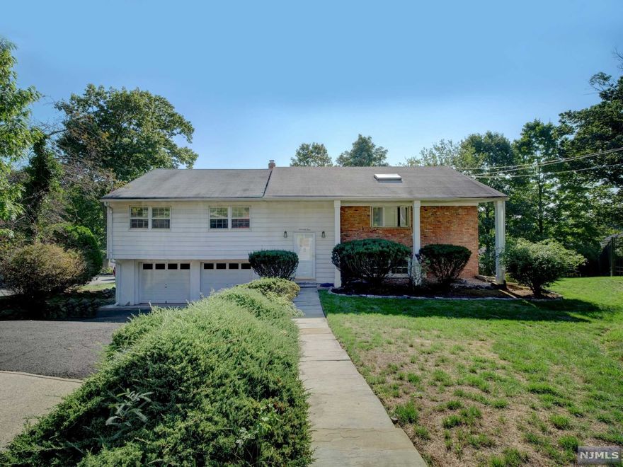 Tucked away on a cul-de-sac and elevated enough for great views this bi-level offers 3 bedrooms, 3 baths and hardwood floors. The open feel of the LR, DR and EIK bring in great light and the primary with ensuite, the downstairs office or 4th bedroom and rec space and built-in 2 car garage will please. Bring your own style ideas to this private location at the end of the block and make this house your HOME. Appliances are AS IS but home comes with a 12 month Cinch Home Warranty for added peace of mind in this peaceful location.