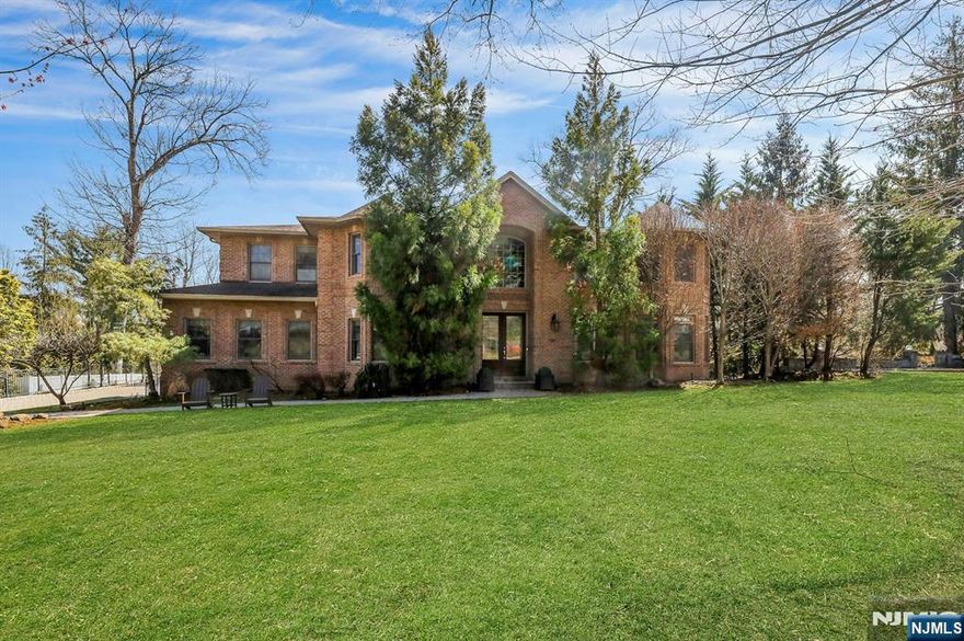 This exceptional all-brick colonial is built to the highest standards, showcasing timeless craftsmanship and refined architectural detail throughout. A bright, welcoming foyer opens to elegant living spaces and a beautifully appointed family room with 9-foot ceilings, intricate millwork, a fireplace, and a custom coffered ceiling. Divided-light oversized windows and French doors fill the home with soft natural light, enhancing its classic sophistication. The chefâ€™s kitchen features top-of-the-line appliances and flows seamlessly into a butlerâ€™s pantry with a built-in wine cooler and formal dining room. Radiant heat enhances comfort throughout the first floor and in the primary bath. Upstairs, the serene primary suite offers dual walk-in closets, a sitting area, and a spa-like bath, complemented by well-appointed bedrooms with ensuite or Jack-and-Jill layouts. The expansive walk-out lower level is a true extension of the home, complete with a fireplace, bedroom, full bath, and potential wine cellar. Bathed in natural light and surrounded by lush greenery, it offers exceptional privacy and effortless indoor-outdoor living - ideal for entertaining or a private retreat. Wired for indoor/outdoor surround sound, a possible wine cellar, a top-rated Blue Ribbon school district, offering convenient commute to NYC, and many more.