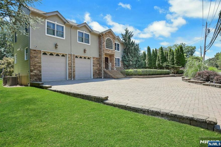 Welcome to this stunning Center Hall Colonial set on nearly half of an acre of private, park-like property. Featuring 4 bedrooms, 2.5 baths, and over 3,350 sq ft of elegant living space plus a finished lower level. The gourmet eat-in kitchen boasts quartz countertops, marble backsplash, and new high-end stainless steel appliances (2020-2024). The family room with vaulted ceilings opens to a large Trex deck (2021) overlooking a lush backyard with paver patios (2020), a heated pool, and a custom-built fire pit area with water & electric. Recent updates include: new roof (2021), gutter guard system (2021-2022), 9-zone sprinkler system w/ new control panel (2024), custom closets throughout, new fence & aluminum gate (2021), and custom garage cabinetry. Ideally located near shops, dining, NYC transit & top-rated Northern Valley schools-this home perfectly combines luxury, comfort & convenience! Call us today!!