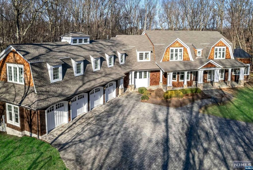 The lifestyle you've been waiting for! This custom built Hamptons style home redefines luxury from end to end. Boasting 4.6 acre of exceptional privacy, the meandering driveway unveils approx 12,000 sf (3 floors) of on-point design and exquisite detail. 6 bed, 6.2 bath, phenomenal millwork, walls of windows framing verdant views. Experience a feeling of comfortability the moment you enter. Each room is positioned for easy living and entertaining. The GR w/coffered ceiling and wood burning fpl, the spacious gourmet kit beaming w/natural light and positioned perfectly next to a huge mudroom and pantry. Multiple doors lead to bluestone covered porches around the home that overlook the estate like property. Also enjoy a commanding office and private guest suite. Upstairs find a LUXE Primary/Spa Bth, 3 add'l BRs, a homework room and a Guest WING providing ultimate comfort for all! Fin LL has 12' ceilings and amazing spaces. Great location, minutes to downtown centers, 2 miles to train!