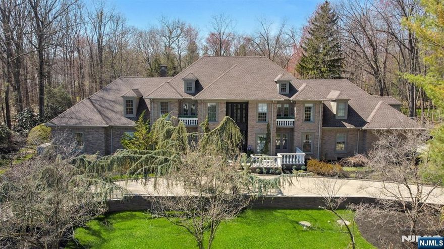 MODERN ELEGANCE,CLASSIC DESIGN,EXCEPTIONAL CRAFTSMANSHIP, & EXQUISITE CUSTOM MILLWORK define this stunning all-brick estate, set on a quiet cul-de-sac in Saddle River. Built by John Avanzato, this home showcases the highest caliber of design & materials throughout. The main level features 9' ceilings,rich hardwood floors, & a seamless open layout,that is perfectly designed for both everyday living & entertaining. From the moment you step into the dramatic 2-story EF, you are welcomed w/a sense of grandeur.The GR impresses w/a soaring ceiling, walls of windows, & a striking FPL that serves as a stunning focal point.To the left, the LUX Primary Suite is a private retreat, complete w/a sitting area,2 fpl's,2 WIC's, & a spa-inspired Primary Bth(2025). Additional highlights include a beautiful LR & a sophisticated office w/FPL. The Award winning Chef's MEIK is a true centerpiece, featuring 2 islands, top-of-the-line appliances, pantry, abundant counter space, & a sunlit breakfast area overlooking the picturesque grounds. A grand staircase leads to the 2nd level, w/ 4 ensuite bedrooms-one ideal for guests-along w/an additional Br & FB.The Finished LL offers an exceptional lifestyle experience, complete w/a home theatre, bar, rec rm,office w/FB, PR, & a gym w/sauna. Step outside to your own private oasis: a fenced in Backyard w/2 outdoor kitchens, stunning lagoon-style pool, cabana, & expansive green space-ideal for relaxation & entertaining! Generator. 3-Car Garage. Just Gorgeous!