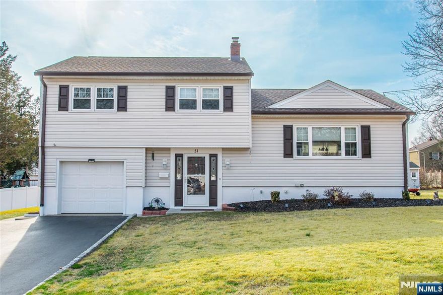 WELCOME to this impressive 3 bdrm,1 full bth & 2 half bth split-level home. This exceptionally maintained home is situated in a prime location of Wayne where strolling the sidewalks give it a true neighborhood feel. The primary bdrm features a walk in closet & its own private 1/2 bth for added ease. The updated light & bright kit offers ample storage, granite counter tops and a seamless flow into the separate dining area. Combine this with the open living room creates the perfect gathering space. Hardwood floors lie beneath the carpeting on 1st & 2nd floor ready to be revealed. Directly off our entryway is the family room with 1/2 bth, laundry and entrance to the garage. Family room offers sliders to a huge flat property with a patio. The finished basement has plenty of added storage and utility room. Some added features include, new roof 2024, C/A 2021, HWH 2020 and transferrable life time warranty on windows. This home gives the feeling of comfort in every corner.