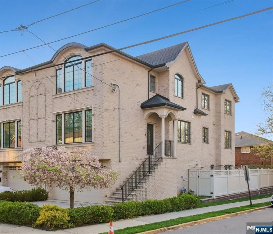 Beautiful, bright & spacious townhouse in the heart of Fort Lee, NJ, built in 2016 and designed for modern living. This home features high ceilings and a bright, open-concept layout. The main level offers a spacious living room with a fireplace, an elegant formal dining area, and a modern eat-in kitchen with sliding glass doors leading to a large terrace. There is also a half bath. Upstairs, the luxurious primary suite includes a walk-in closet and a spa-inspired bathroom with double vanities, a Jacuzzi tub, and a separate glass-enclosed shower. Two additional generously sized bedrooms, a full hallway bath and laundry area complete the second floor. The ground level features a spacious family/recreation room, with area for a home office, and a half bathâ€”offering flexible space for guests, work, or leisure. Enjoy a private fenced backyard & patio for added comfort and privacy. Two car garage outfitted with an EV charging station. Ideal commuter location with NYC public transportation across the street. Beautiful home in a great area. A rare opportunity not to be missed!