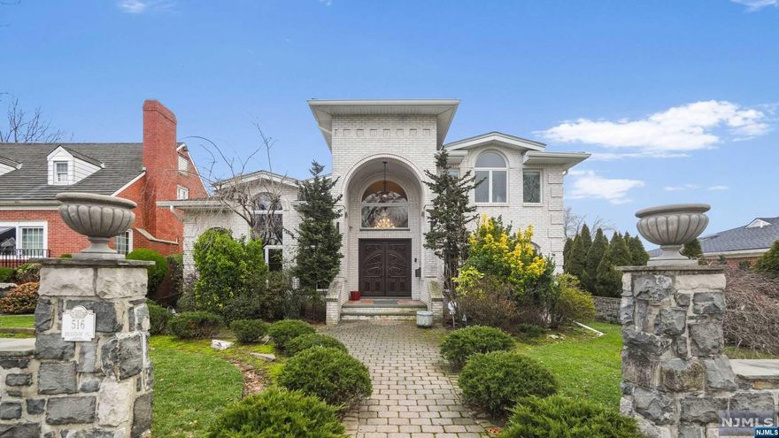 Nestled in Cliffside Park's Bluff section, this meticulously renovated center hall colonial home spans a full block. With a rebuilt rear porch boasting winter views of NYC, the 14-room residence includes 4-5 bedrooms and 3.5 baths, featuring radiant heated floors. The extended family apartment underwent a thorough renovation, showcasing a gourmet kitchen and mold-resistant installation. The completely renovated 3rd level has a gorgeous master suite, 2-3 bedrooms and full bath.. Exterior renovations include a new roof, 5" gutters, French drains, 3-zone central air conditioning, a 6-zone furnace, and two hot water heaters. The entrance welcomes you with a grand 2-story foyer and living room. The family room has a wood-burning fireplace and access to the 400 sq ft porch shared with the eat-in kitchen. Ample storage and closet space are found in generously sized rooms. The property includes a 2-car garage and a private yard with a stone fireplace, offering a cozy outdoor space.