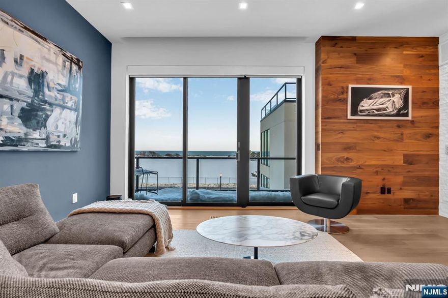 A rare opportunity to experience uncompromising oceanfront living. This five-bedroom, five-bath multi-level residence captures panoramic, unobstructed Atlantic views from nearly every room, with walls of glass that fill the home with natural light. The open-concept living and dining areas are anchored by a designer chef's kitchen featuring premium appliances, bespoke cabinetry, and quartz countertops, while a custom-built full bar enhances the home's entertaining appeal. Expansive terraces and a private rooftop deck create seamless indoor-outdoor living, complete with an outdoor kitchen and ice maker -- the perfect setting for hosting above the shoreline. A private elevator, spa-inspired primary suite, in-unit laundry, generous storage, and an attached garage complete this elevated coastal retreat.