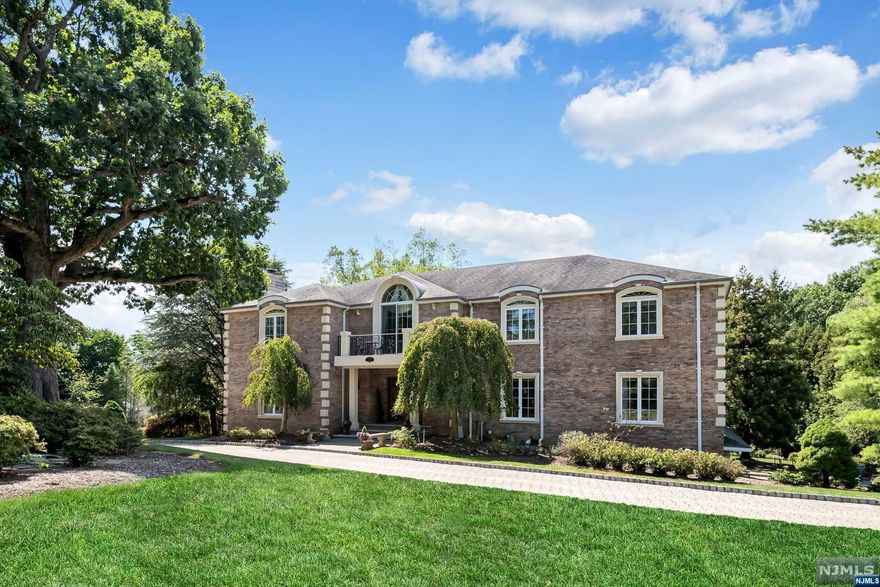 Majestic 5 bedroom Manor on beautiful acre property offers a peaceful, elegant retreat with extensive custom millwork & details. Grand 2 story foyer with marble flooring welcomes you & leads to the formal living room with gas fireplace & accent lighting. French doors open to the sun filled private library with walls of windows & coffered ceilings. Formal dining room & butler's pantry opens to huge updated (2012) kitchen, large island & breakfast rm with fireplace. Doors open to large private deck. Spectacular 2 story great room with fireplace, bar with martini shaped custom sink, floor to ceiling windows & open to an inviting sunroom with walls of windows. 1st floor bedroom suite with full bath. 2nd floor balcony leads to primary bedroom with tray ceiling, luxurious bath, & huge walk-in closet. 3 spacious bedrooms plus 2 more updated full baths. Walkout lower level features billiard/family rm with fireplace, home theater, gym, guest space, full bath. Windows 2012, 3 car garage.