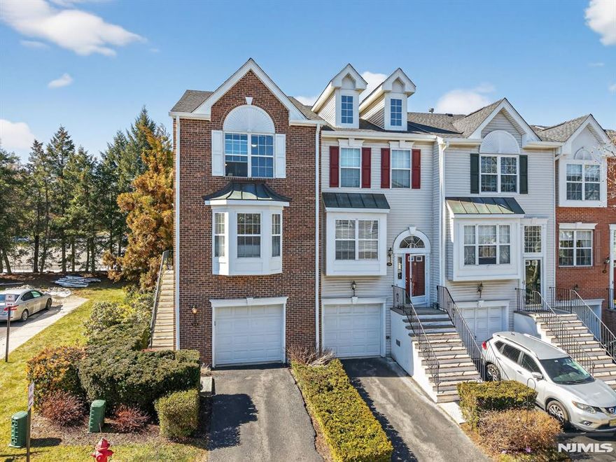 Beautiful end-unit townhouse in the gated Cambridge Heights community of Nutley offering approximately 1,790 sq ft of living space. This well-maintained home features 2 bedrooms, 2.5 baths, 9' ceilings, oversized windows, recessed lighting, and Brazilian cherry hardwood floors throughout the main living areas. The updated kitchen includes granite countertops, additional cabinetry, two pantries, and a breakfast bar. The dining room features a gas fireplace and opens to a spacious living area. The primary suite offers a fully renovated ensuite bath with Turkish marble tile, granite countertops, and two closets. The finished ground level provides flexible space for a guest room, office, or recreation area and includes access to the oversized attached garage, larger than most in the community. Additional features include newer windows, brand new roof, 2024 hot water heater, and a new central air and forced hot air system to be installed prior to closing. Residents of Cambridge Heights enjoy outstanding amenities including a clubhouse, pool, tennis courts, fitness center, sauna, playground, and entertainment room. The home is ideally located on a cul-de-sac within the community with easy access to NYC transportation, including an express bus to Manhattan, and is just minutes from the train, major highways, shopping, dining, Target, and Walmart. A rare opportunity to own a spacious end-unit townhouse in one of Nutley's premier gated communities.