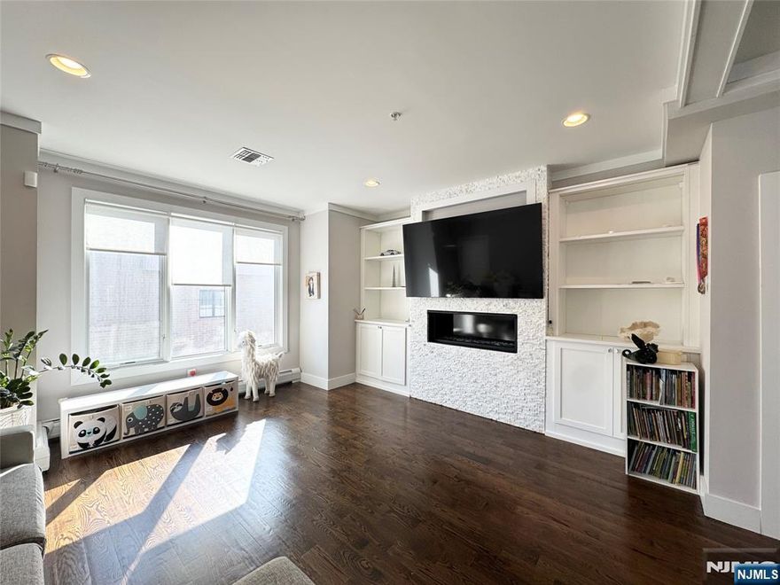 This 2017 built newer townhouse is located at the desirable Fort Lee NO.1 Elementary School area (Walking Distance). Entering the house you will find the open floor plan with 9 ft ceilings and hardwood floors throughout and the formal living room with gas fireplace, formal dining room, eat in kitchen with granite countertops and stainless-steel appliances as well as a half bathroom. Upper level has 3 bedroom, 2 full bathroom. You have a Roof Top Deck with GW Bridge view/Lower Manhattan view/Fort Lee City view as well as a Louge Room/Library on the 4th Floor. The ground level consists of a 1-car garage with an additional covered 1 car parking space and the Laundry Room. It's also equipped the Water Softener System for the whole house. Minutes walking distance to the nearest bus stop and Fort Lee Main St / the George Washington Bridge. Minutes driving distance to I-95 & NJ Turnpike. Close to restaurants, parks, cinemas, shopping mall. SOLD AS IS, make it your sweet home!!