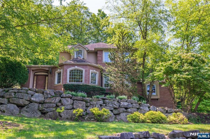 Welcome to this custom Colonial entertainer's dream home! Located on a cul-de-sac in the sought-after Kensington Wood neighborhood and backing up to parkland, this home blends timeless elegance with modern convenience and privacy. The inviting foyer leads to an open floor plan, perfect for everyday living hosting guests. The large kitchen features granite countertops and a breakfast bar, opening to a light-filled dining area and family room with a gas fireplace and backyard views. The large living room offers even more relaxation space with a second gas fireplace. The first floor also features a large bedroom with its own en-suite bathroom, perfect for guests. Outside, a spacious patio is the perfect place to create an ideal space for al-fresco dining and entertaining. The upper level offers three generously sized bedrooms with connected bathrooms, including a large primary suite with an en-suite bathroom with a large skylight, soaking tub, stall shower and double-sink vanity. A finished basement with a wet bar, tons of storage throughout, a complete house generator and access to the 3-car garage complete the package.