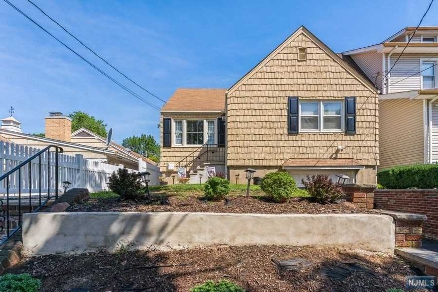 Come and see this beautifully renovated, turn-key home in Clifton, New Jersey, ready for you to enjoy! So much to offer with three bedrooms, two full baths and a full, finished basement. The kitchen is complete with white, hardwood, shaker cabinets, quartz countertops, subway tile backsplash and stainless steel appliances. The first floor features two bedrooms and a newly- renovated bathroom. The second floor features a primary bedroom, full bath and plenty of storage space to suit your needs. The full finished basement is very spacious and features a laundry area and access to the attached garage. The first and second floors have hardwood floors and recessed lighting throughout. Heading outside you will find perfectly manicured landscaping surrounding the home. Escape to your private backyard to enjoy the outdoors. The backyard is enclosed with new PVC fencing for privacy. NYC transportation steps away and very reasonable taxes. Just unpack your bags and move right in!