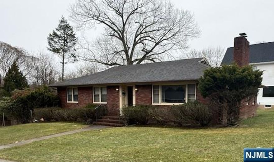 Brick Ranch on a corner lot featuring Living room with fireplace, Formal Dining room, Eat-in kitchen, three Bedrooms, Enclosed porch and Full Bath. The ground level offers garage access and includes an Office, Rec room, summer Kitchen, Full Bath, and Laundry room, providing flexible living space. Two-car built-in garage. Conveniently located approximately 30 minutes from NYC and close to parks, transportation, schools, dining, and shopping. Home is being sold in as-is condition.