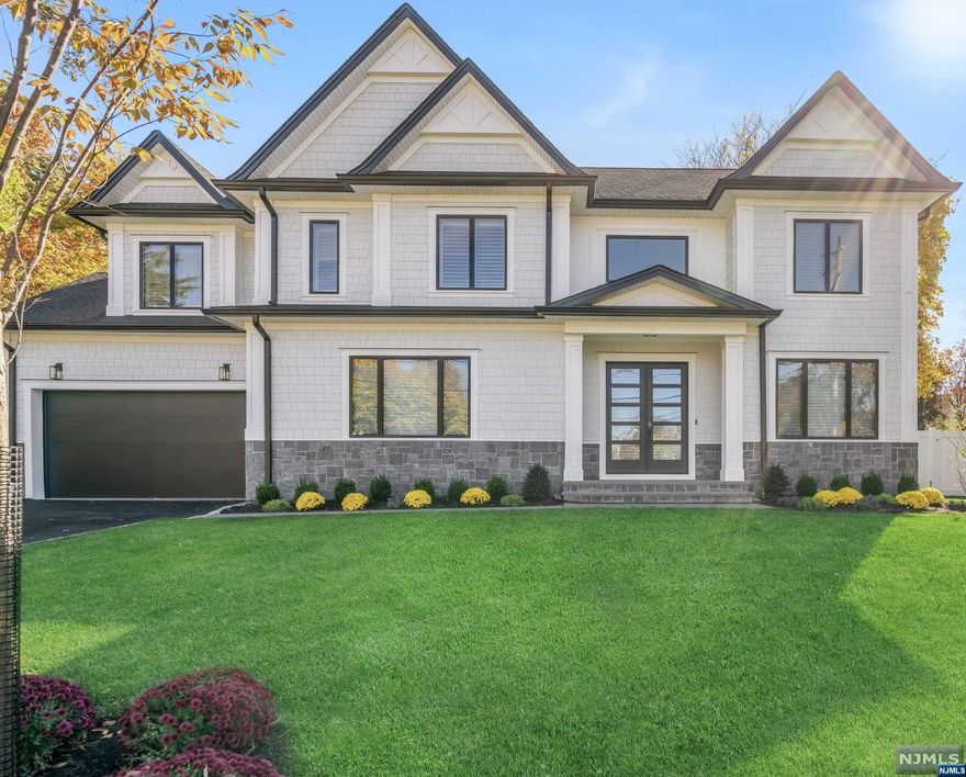 Welcome to this fully completed new construction home in the heart of Closter's East Hill. Dramatic 2-story foyer opens to the formal living room and banquet-sized dining room with coffered ceilings. The stunning Chef's kitchen offers an expansive Calcutta waterfall island with 2nd prep sink, Bertazzoni appliances, & furniture-grade cabinets made in Italy. Open concept kitchen flows to the breakfast area with sliders to the bluestone patio and light-drenched family room with dramatic floor-to-ceiling fireplace on one side, and butler's pantry on the other. The second floor hosts the primary bedroom ensuite with dual walk-in closets & spa-like bathroom as well as a junior ensuite with tub, 2 more bedrooms with Jack & Jill bathroom, and laundry room. The full expansive finished basement features a rec room, play room, theater room, bedroom with bright egress windows, gym/office & storage. With custom window treatments and generator already installed, this gem is truly move-in ready!