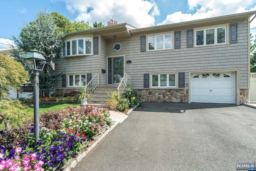 4 bedroom, 2 1/2 bath bi-level in the Battle Hill section of town. Perfect mother-daughter or extended living, situated on a 60' x 100' lot. Built in 1 car garage & double wide driveway. Lower level features a full summer kitchen, living room, 1 bedroom, full bathroom with stall shower, laundry, and walk-out to patio. The main level features a living room, dining room with skylight, kitchen with granite countertops & center island, 3 bedrooms and 1.5 baths. Hardwood floors on the main level, and laminate flooring on the ground level. Screened in patio overlooking an in-ground pool from 3' to 8' deep was refurbished in 2022. Roof 3 years old. Vinyl Privacy fence. Shed in rear. 2 zone gas hot water baseboard heat, central air conditioning, 200 amp electric. 2 blocks to bus to NYC. Electric is wired for a portable house generator. Close to school, major highways 78, GS Parkway, and close to Newark International Airport. Seller holds NJ Real Estate Salespersons License