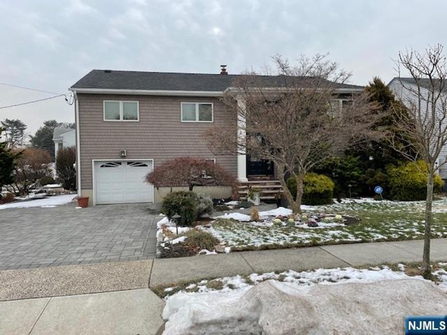 Bi-Level home in move-in condition. LR(12x13), DR(11x12) w/SGD to deck with stairs to yard., Modern Kitchen w/newer cabinets and quartz counters. 3 bedrooms (10x11), (11x12), 11x14), Modern bath w/Jacuzzi. Bessler stairs to attic storage. Ground level has Family room (11x23) w/half bath, a large (12x17) room that could be an office or 4th bedroom, and a large laundry room/furnace room. Rear patio and shed. Gas HWBB 3 zone heat and central a/c. I car garage and block driveway fits 4 cars. Nice landscaped lot. Utility easement on White Terrace side of home. Hardwired smoke detectors, Alarm system. Low East Rutherford Taxes.