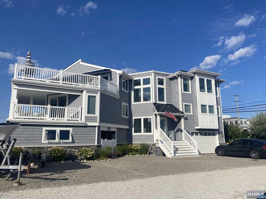 This Elite LBI home is perfectly situated in beautiful Loveladies. Completely rebuilt and enlarged in 2019. Just steps to the beach or the bay with a two deeded slips and private dock. Get the best of both worlds. This property boasts a resort-style outdoor oasis complete with a gunite pool, alfresco kitchen, two fire pits, and an outdoor shower. Designed for seamless entertainment, the open floor plan effortlessly connects the living spaces, and the large windows bathe the interior in a plethora of natural light. This coastal home includes a large recreation/game room, elegant kitchen and dining area leading to a large deck with bay views. This 4268 square foot home offers 6 bedrooms, 4 full baths and 2 half baths. The perfect blend of sophistication and comfort, you don't want to miss it!