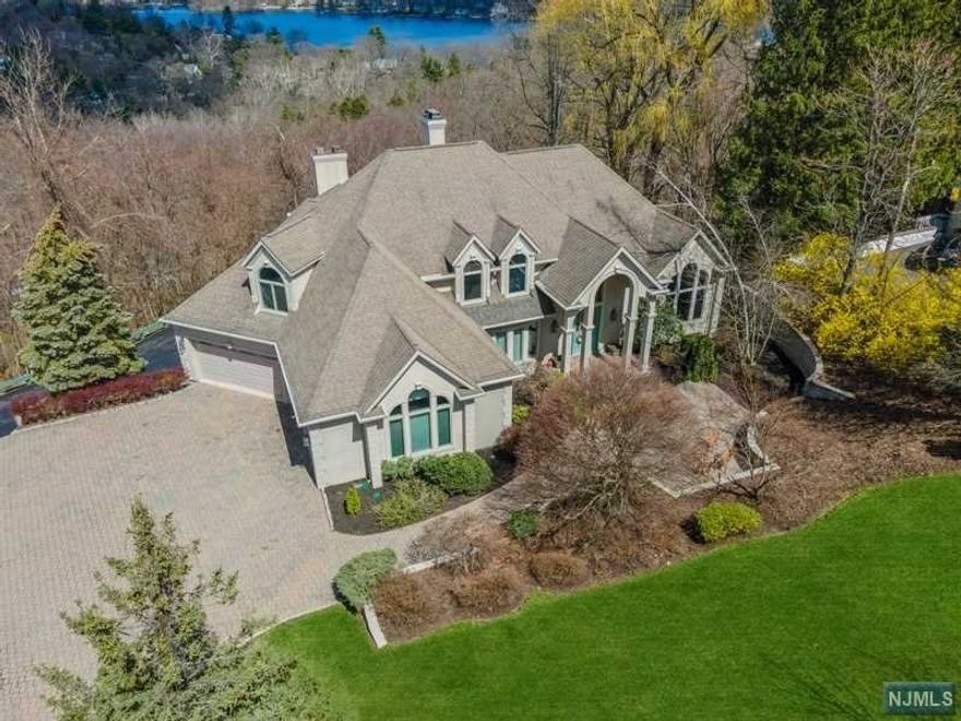 Situated within Vizcaya Estates, this custom built home offers 7,000 Sq. ft. of living space. The gracious 2-story marble entry foyer greets you to a curved staircase, sunken living room w/fireplace & panoramic views of the mountains & lake. Open flow kitchen features custom cabinetry, granite counters, breakfast room w/vaulted ceilings leading into the family room w/gas fireplace. 1st floor includes powder room, butler's pantry & laundry/mud room, Luxurious first floor primary suite w/ tray ceiling, spacious closet, bathroom & sliding glass doors leading to deck. All bedrooms have walk-in closets and private bathrooms. 2nd fl. has 3 separate storage/attic spaces for future expansion. The light filled lower level is perfect for extended living/long-term guests w/high ceilings, 2 separate rec-rooms, fireplace, wet bar, media room/space & bathroom. Additional highlights: Temperature controlled 8+ car garage, multi-zone heating/cooling, paver driveway, steel beam construction.