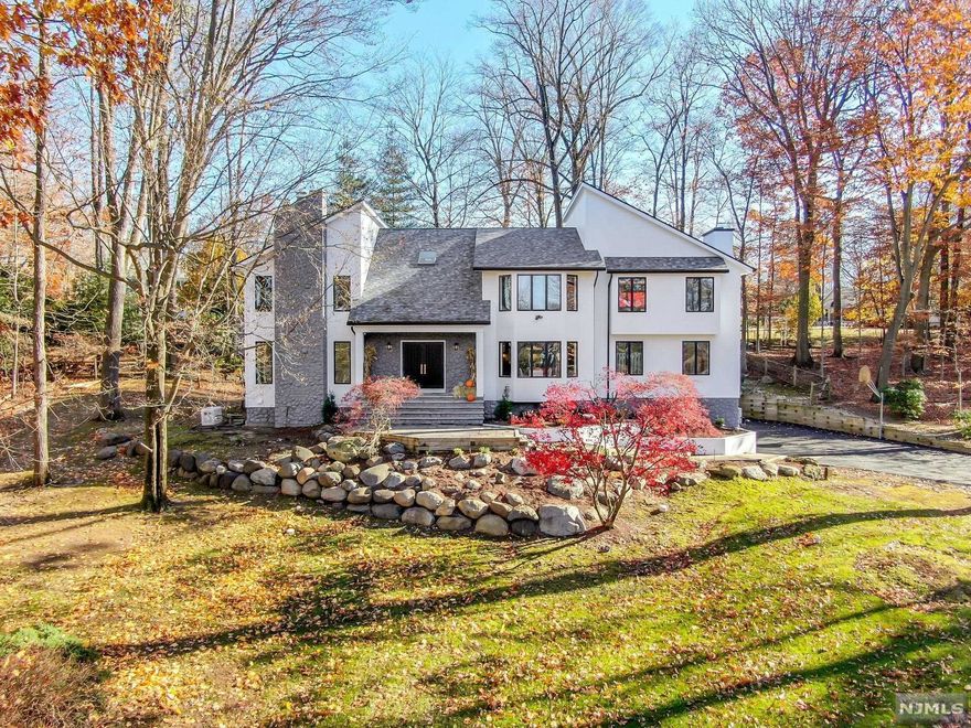 Exquisite, fully renovated contemporary on cul de sac in Old Tappan, offers new hardwood floors, soaring ceilings and custom details throughout. Breathtaking foyer with 2-story entry, porcelain tile and modern glass banister. Open living room with gas fireplace. Banquet-sized dining room and state-of-the-art kitchen featuring 10 ft center island, Quartz countertops, custom white oak cabinets and Thermador appliances. Expansive great room with cathedral ceiling, custom fireplace and sliding doors to yard. Large bedroom and full bath completes 1st level. Second level offers luxurious primary suite with vaulted ceiling, custom fireplace, walk-in closet, and primary bath with vaulted ceiling, custom white oak vanities, marble shower and soaking tub. Two large bedrooms, glass-enclosed loft and laundry completes 2nd level. Finished lower level offers laundry rm, family rm, fitness rm, spacious bedroom and full bath. Architectural plans for pool and landscape available..