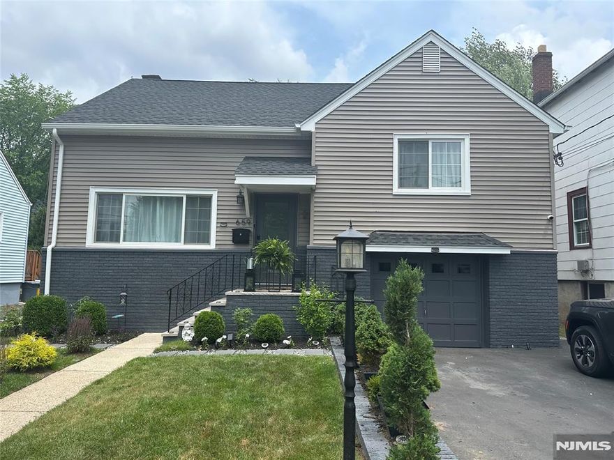 This pretty and perfect Split-level home makes it easy for you to just move in and enjoy it. No heavy lifting here. It's move-in-ready. The light and bright living room is open to the dining area with ready-made built-in benches. There's also a door to the outside private retreat, complete with botanical gardens and grand paver patio. The updated work kitchen has stainless steel appliances and granite countertops. The upstairs features two bedrooms and an updated full bath with the next level featuring the private Primary bedroom with abundant natural light with the two skylights and closets galore. There's a half bath, a semi-finished full basement and full garage with charger. This great house is located close to parks, houses of worship, shopping and transportation to NYC.