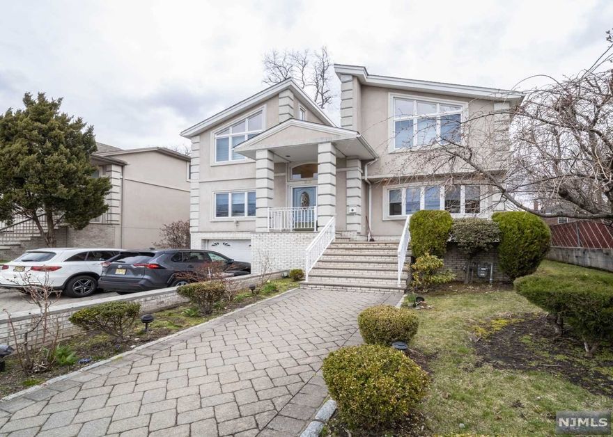 Exquisitely renovated and fully custom-built center colonial home in a prime location of Fort Lee. The top quality of the home can be seen from first glance looking at the paved driveway and stucco finished throughout the exterior of the home. Step into the bright and open home to find the fully renovated features including the modern eat-in kitchen, living room, family room, and more. Upstairs, you can find three spacious bedrooms, generous full bathroom and the breath-taking master suite with the elegant ensuite bathroom. Full and finished ground floor offers a home theater perfect for entertainment, separate office space, laundry, and a powder room. Much sought after Elementary School #4 is the elementary school for this home. Location offers close proximity to NYC transportation, places of worship, restaurants, and more. Come and see for yourself to appreciate this phenomenal home!