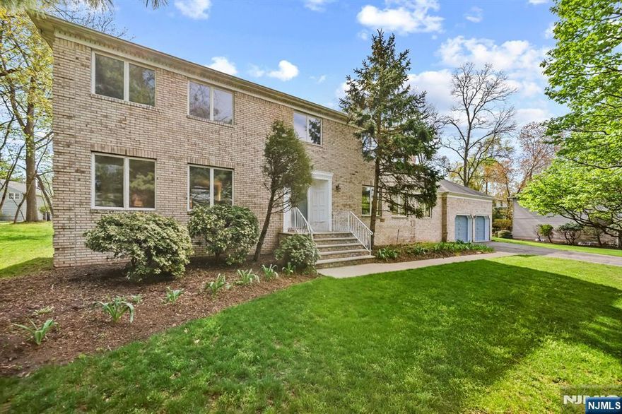 Idyllic Colonial Manor on a prime cul-de-sac in the heart of Closter. This meticulously maintained brick-front home offers over 3,750 sq. ft. of elegant living on a private .37-acre property. Featuring 5 bedrooms and 3.5 baths, this residence blends timeless elegance with modern comfort. A welcoming foyer leads to a formal dining room and spacious living areas. The modern eat-in kitchen offers ample cabinetry, center island, and sliders to an expansive deckâ€”ideal for indoor-outdoor gatherings. The dramatic great room features vaulted ceilings, skylights, a stone fireplace, and entertaining wet bar, creating a bright and inviting centerpiece. The main level also offers a bedroom with adjacent full bath and private entry, perfect for guests or extended family, plus a powder room and direct garage access. Hardwood floors and quality finishes run throughout. Upstairs, the primary suite boasts a spa-like bath with jetted tub, double vanity, and stall shower. Three additional bedrooms and a full bath complete the second floor. The finished basement offers flexible bonus space for customization. Enjoy outdoor living on the expansive deck with electric awning and private backyard. Close to NYC transportation, TOP-rated schools, shopping and dining. Exceptional home in sought-after location. Donâ€™t miss out, this one is sure to impress!