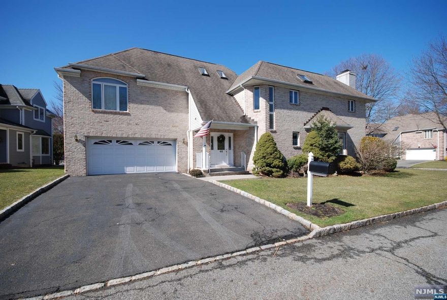 This well-designed brick front Colonial sits in a peaceful neighborhood with a private backyard! A quality built home with large rooms to enjoy & plenty of closets to fill. An impressive primary bedroom suite with a spa-like bathroom. A bright & airy kitchen w/separate area for a table open to the formal dining room, family room & living room. The finished basement offers a recreation room w/full bathroom plus another small room perfect for a wine cellar. Features include high ceilings, specialty windows (Andersen casement style throughout), baseboard heat, newer HVAC, two-car garage & secluded deck. Very close to shops, restaurants, schools (Blue Ribbon school district) transportation (less than a mile to train/bus). A prime location in a town with so much to offer!