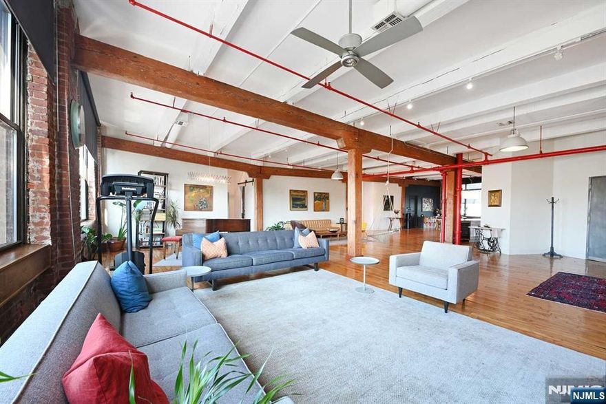 Rare and fabulous true loft living along the Palisades with one car deeded parking. This incredible 4220 square foot home boasts original hardwood floors, soaring 13 ft ceilings, exposed brick and beams and preserved industrial elements. Enter the unit through a keyed elevator and onto an expansive open floor plan bathed in light with large east and west facing windows, and winter views of NYC. With a Viking refrigerator, Thermador stove, granite countertops, large island and plenty of storage, cooking and entertaining are a dream. Currently used as a four bedroom with two full baths and two additional rooms for office/ gym and children's play space, the existing layout offers many configurations. An oversized pantry plus closets throughout provide a place for everything. Excellent access to the bus and tunnel makes commuting a breeze. Great walkable neighborhood just minutes from the Union City Reservoir Walk and bordering on Hoboken, and Jersey City for easy enjoyment of these communities as well.