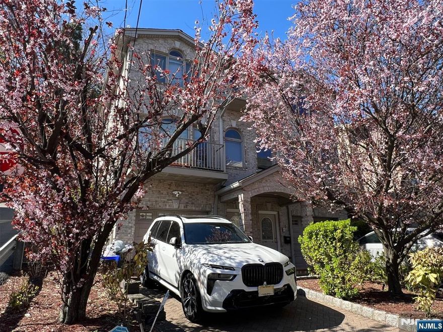 Here's your chance to live on one of Edgewater's most desirable streets. Moments to both downtown Edgewater and Fort Lee where you'll find countless amenities, restaurants, and activities to enjoy with the family. Plenty of space to work from home, Take a ride through the cliffs overlooking the Hudson, or have a picnic in the Ross Dock Picnic Area. Spacious open floor plan living area and stainless steel kitchen with separate laundry area. Sliding doors on each end of the home give access to a balcony and stone patio, a perfect place for your plants. Decorative hardwood floor inlays and recessed lighting throughout. Opulent Primary Bedroom with private Ensuite Bathroom with nicely sized bedrooms and Full Bathroom. Endless options with the ground floor family room and full bathroom for a dedicated office/theater/playroom with a private side entrance. Photos are of a similar home.