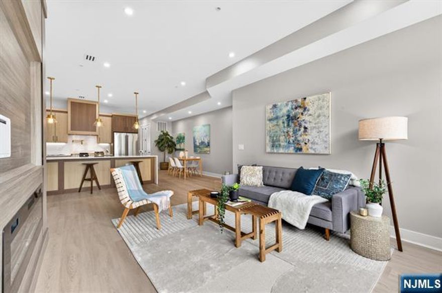 Welcome to 172 Griffith St, Unit 1, a beautifully crafted 3-bedroom, 2-bath condo that captures the modern spirit of Jersey City Heights. Sunlight pours into the expansive living room through oversized windows, highlighting rich hardwood floors and a sleek electric fireplace with TV hookupsâ€”an ideal focal point for relaxing or entertaining. The open-concept layout flows seamlessly into a stunning gourmet kitchen, featuring a dramatic waterfall peninsula that doubles as a breakfast bar while still allowing space for formal dining. The kitchen showcases striking two-tone cabinetry with contemporary black hardware and a premium GE Café stainless steel appliance suite, including a 6-burner range with optional griddle, pot filler, XO hood, built-in drawer microwave, and Frigidaire wine fridgeâ€”perfect for hosting. Function meets design with a dedicated storage room, additional hall closet with custom shelving, Nest thermostat, Navien hot water heater, central air, and full-size Samsung washer/dryer. The hall bath offers a floating vanity and soaking tub, while the primary suite features a large custom walk-in closet and spa-like bath with rainfall shower. Enjoy direct access to your private backyardâ€”ideal for relaxing or entertaining. Parking available nearby for a fee.