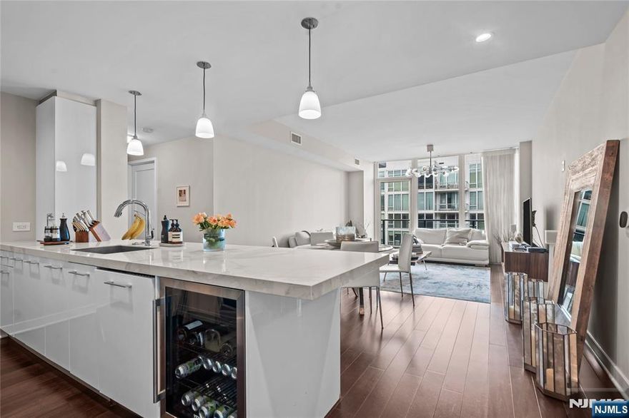 Discover modern luxury living at its finest in this stunning 3 Bedroom / 3 Bathroom residence at the prestigious 1200 Avenue at Port Imperial. Spanning 1,733 SqFt, this sophisticated home offers sweeping northern exposure with breathtaking views of the NYC skyline and Hudson River. Step inside to find an expansive open layout with floor-to-ceiling windows, gleaming hardwood floors, and a private balcony perfect for entertaining or unwinding with a view. The chefâ€™s kitchen is designed to impress, featuring GE Monogram appliances, Caesarstone and Italian porcelain countertops, custom cabinetry, and a breakfast bar. The luxurious primary suite boasts a spacious walk-in closet and spa-like ensuite with soaking tub, glass-enclosed shower, and double vanity all complemented by stunning city views. Two additional bedrooms and full bathrooms provide comfort, privacy, and versatility for guests or a home office. Residents of The Avenue Collection enjoy an unmatched lifestyle with 24-hour concierge service, a state-of-the-art fitness center with steam rooms and sauna, library lounge, cinema room, childrenâ€™s playroom, skyline social lounge, outdoor pool, firepit, cold storage, and more. With garage parking and the NY Waterway Ferry just steps away, this home offers the ultimate blend of luxury and convenience along New Jerseyâ€™s Gold Coast.