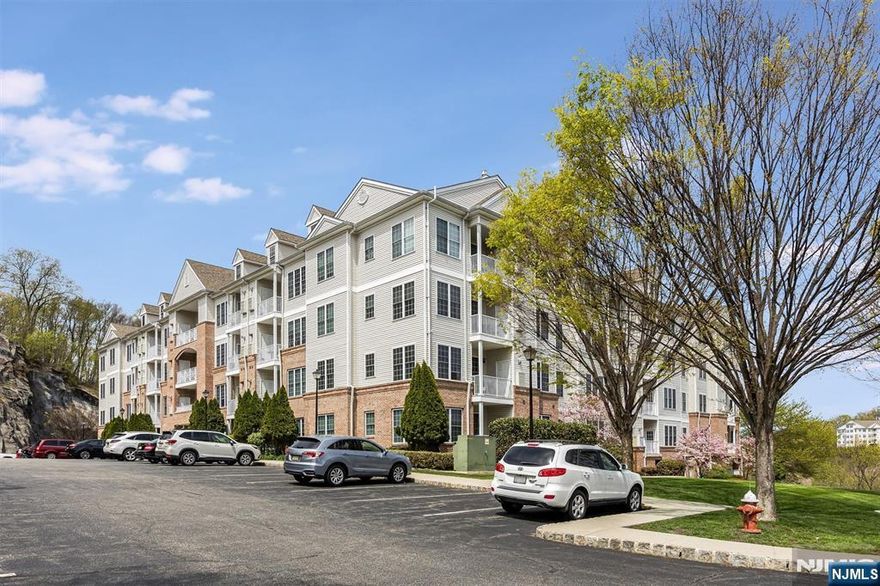 Move right into this elegant 2nd-floor condo in Building 6, perfectly situated across from the clubhouse, tennis courts, and pool, offering both convenience and beautiful views. This spacious Unit features 2 bedrooms and 2 full baths, with each bedroom offering its own walk-in closet for maximum comfort and storage. The updated kitchen boasts rich cherry-finish cabinetry, granite countertops, breakfast bar and mini bar w/wine fridge, ideal for everyday living and entertaining. Additional highlights include a tech center, surround sound system with built-in speakers, and a newer washer and dryer. Step out onto your private balcony and enjoy scenic views in a peaceful setting. The Grande offers 2 clubhouses, 2 pools, tennis courts, fitness ctr, billiards rm, conference rms, party rms & much more. Parking is effortless with a one-car garage space located directly beneath the building, plus additional guest parking. All this in a highly convenient location close to major highways, shopping, and dining.