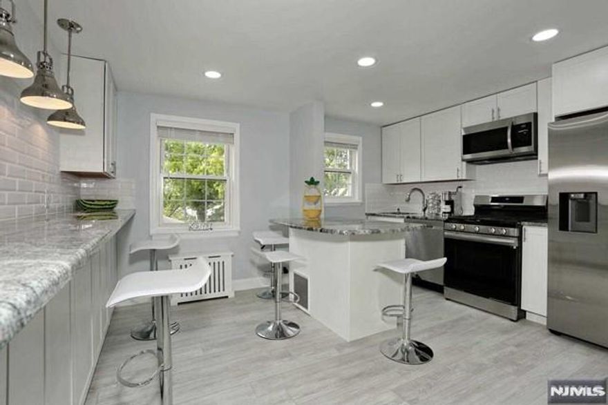 Only one on the Englewood market for sale - gorgeous fully renovated condo with 2 parking spaces - a deeded garage with an automatic door opener & outdoor condo parking in the best East Hill area of Englewood, located on the picturesque grounds with manicured lawns on a quiet side street in the heart of Downtown Shopping & Restaurant District! 10 min drive to NYC! NYC express bus & local buses out front. Stunning sun drenched modern fully renovated 2 bedroom unit with 5.5 feet height attic above the entire unit for storage; new electric panel, new state of art eat-in open concept windowed kitchen with oversized breakfast bar, island, granite countertops, & stainless steel appliances. New gorgeous windowed bathroom, new floors, large windows, 6 huge closets, modern electric fireplace, recessed lighting. Ample free street parking. New laundry facility. Walk to the library, Bergen Performing Arts Center, yoga & hot yoga, Shoprite, Englewood Hospital, parks, Houses of Worship, & all restaurants imaginable! Garden style building with benches outside. Dogs & cats friendly. No restrictions on renting. Could be rented out immediately. Garage is separately deeded (annual tax $218.12, monthly maintenance $67.05, & monthly assessment $14.67), but is included with the sale of the unit & in the listing price of the unit. Amazing very responsive management company keeps the entire building & its grounds in perfect condition. Superintendent on premises. Great community! Relative has NJRE.