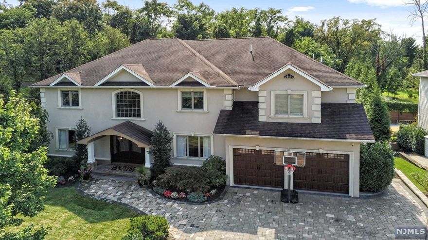 Unparalleled detailed craftsmanship offered in this 5 Bedroom 5 Bath Colonial on quiet cul-de-sac location. This sophisticated home greets you with a two story entry foyer & open floor plan for entertaining. This home has it all! Magnificent backyard oasis with free form pool and Jacuzzi, outdoor living area w/fireplace and built-in Kitchen, plus room for play buffered with natural backdrop of woods for privacy & serenity. Embellished with a Chef's Kitchen that opens to a 2 story Family Rm with gas fireplace, millwork, hardwood floors t/o. and dramatic stair case. Banquet sized Dining Rm, main floor Office/Guest suite w/ Bath. Luxurious MBS w/ en-suite bath & his/hers WIC. and sitting area. Guest suite with bath & Add'l 2 bedrooms and main bath. Walk-out basement offering Rec Rm, play area, full bath, wet bar and more! Packanack Lake Rights- sought after community!