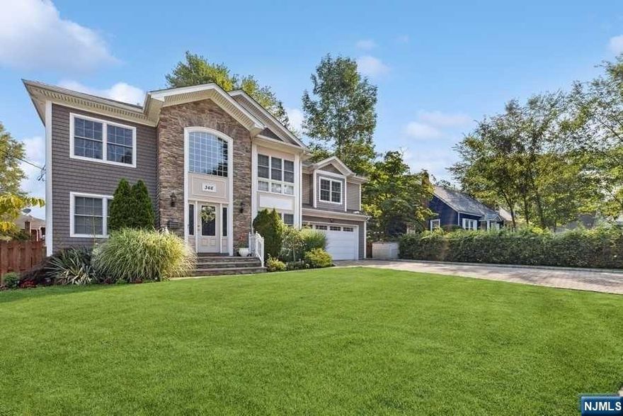 Experience the epitome of luxury in this stunning 5-bedroom, 3-bath colonial, construction completed 2014. 3352 sq ft as per tax record. Two-story entry foyer with grand staircase opens to sitting room. Gourmet EIK w/ huge island and walk-in pantry opens to great room w/ cathedral ceilings and surround sound speakers and formal dining rm. Large fenced in backyard w/ patio, outdoor speakers and flood lights for outdoor entertaining day/night. Primary suite w/two large walk-in closets, sitting area currently used as a full home gym, primary bath w/jacuzzi and double sink vanity. Grand staircases to both the second floor and full finished basement with bonus rm/office make this extremely custom find. Oversized garage, paver driveway, and a captivating stone facade. This home and location offer the best of it all. A true luxury home in a sought after community close to the sought after River Edge and River Dell School Districts, Van Saun Park, bus/train to NYC, and Paramus shopping!