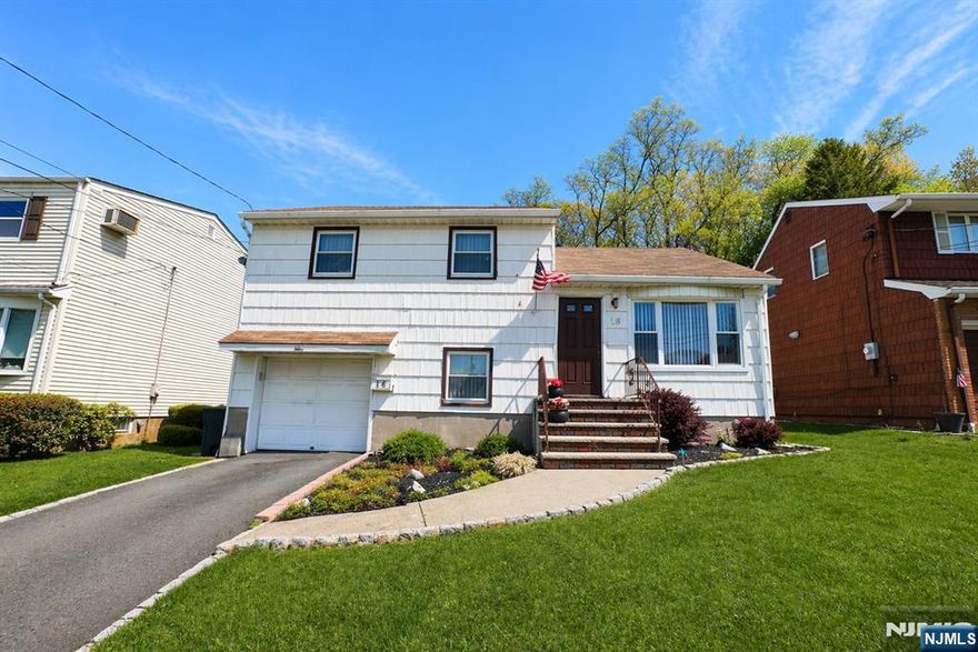Spacious Split-Level home offering a bright living room, formal dining room with sliding doors leading to a deck, and a well-appointed kitchen. The home also features a comfortable family room, three bedrooms, and 1.5 bathrooms. A walk-up attic provides flexible space ideal for a home office or additional storage, while the partially finished basement adds even more versatility. Recent upgrades include a newer furnace, central air conditioning, and hot water heater. Complete with a one-car garage, this home is conveniently located near parks, major highways, and transportation to NYC.
