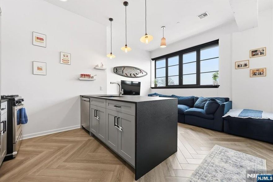 Rare opportunity to own a piece of Heights history at The Packard Jersey City. This boutique collection of just 14 luxury condominiums is housed in a gorgeous converted Packard Motor Car Company showroom. This 1928 building offers a striking blend of modern finishes and preserved industrial character. The steel-and-concrete construction, loft-style building, delivers timeless architecture reimagined for contemporary living. Penthouse 3 is a thoughtfully designed, South facing, two-bedroom two-bath residence featuring an open layout and high-end finishes throughout. The kitchen is equipped with stainless steel appliances, under-mount sink, breakfast bar, and leathered granite waterfall countertopâ€”ideal for everyday living and entertaining. Two outdoor spaces, both a private terrace off the primary bedroom and a larger terrace off the 2nd bedroom shared with four other penthouse units. Additional highlights include central air conditioning, Navien on-demand tankless water heater, in-unit washer-dryer, soaring 12-foot ceilings, exposed concrete beams, visible ductwork, and engineered herringbone hardwood flooring. Conveniently located in the center of everything Jersey City Heights has to offer, including restaurants, shopping, cafés, and parks. Easy access in 40 minutes to either midtown or downtown Manhattan.