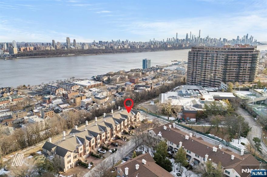 info@29victoriaplaceeast.com // Exceedingly Luxurious Three-Level Townhome with Chic Gourmet Kitchen and NYC Views! Located in the coveted community of Kensington Park only minutes from Whole Foods and the George Washington Bridge, this 3BR/2.2BA residence captivates with a gorgeous brick exterior, two-car garage, and a custom paver driveway. Step into the stylish interior to discover a grand foyer, wood floors, custom built-ins, and a European-inspired gourmet kitchen with premium stainless-steel appliances (Sub-Zero), sleek cabinetry, breakfast bar island, quartz counters, and gas cooktop. Entertaining options abound with a living room w/fireplace, formal dining area, finished lower-level rec room, and an expansive deck featuring breathtaking cityscape views. Unwind in the oversized upper-level primary bedroom with tray ceilings, custom wardrobe closet, and an en suite boasting a soaking tub, separate shower, and dual sinks. Other features: elevator, laundry room, 2 powder rooms, covered patio, and more!