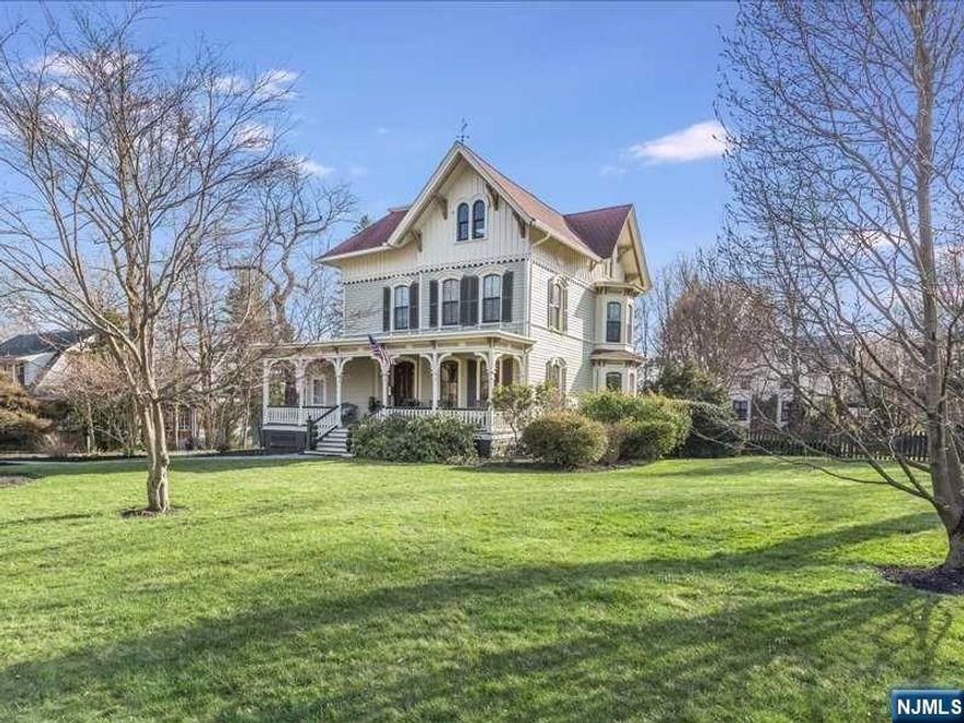 This historic Queen Anne Victorian home is a stunning architectural gem with intricate exterior details, decorative shingles & a grand porch. Inside, original details blend beautifully with modern colors and finishes, including wide moldings, oversize windows, & graceful arches. The spacious first level offers a cozy family room with a bay window & fireplace, a dream kitchen with marble counters and high-end appliances, a sunlit breakfast room, a formal dining room, & a stunning sunroom. The primary suite on the 2nd floor features a luxurious en-suite bath & custom closet, along with two additional bedrooms and a full bath. The 3rd floor offers three more bedrooms, one with an en-suite bath. The landscaped yard includes a deck & patio for outdoor dining. This unique home also features a 2-car garage & central air conditioning. Located near schools, transportation, and the vibrant town of Montclair, this Queen Anne Victorian is a rare find that must be seen to be fully appreciated.