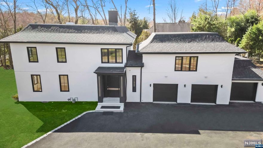 Exquisite luxury modern colonial. Meticulously crafted w/ attention to detail. Seamlessly blends classic colonial charm w/ modern amenities. Spacious/open floor concept- 5 BDRMS & 5.5 baths offers ample space for relaxation. Engineered French White Oak hardwood flooring graces entire house, adding a touch of warmth & luxury. The kitchen showcases a Calacatta marble waterfall island & hood, beautifully wrapped in matching marble, creating a focal point that is as functional as it is breathtaking. A dual fireplace (LR) provides a cozy ambiance, perfect for gatherings or relaxing evenings. Thoughtfully designed layout. Upstairs, you'll find the spacious primary bedroom, comfort & luxury at its finest. The primary bath features marble herringbone flooring & high-tech smart shower w/ electronic touch screen, ensuring a spa-like experience. Showroom- custom walk-in closet. 3 large en-suites w/ FBTHS. Radiant heating throughout. The attention to detail extends far beyond the aesthetics.