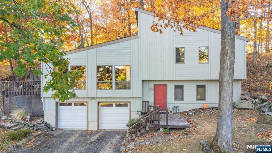 Updated contemporary split level with lots of space for everyone to spread out! Located in the very sought after Alpine Section of Lake Mohawk. Gorgeous Hardwood floors, soaring ceilings! Updated kitchen with granite countertops! Open floorpan with tons of natural light! 3 bedrooms, 2.5 baths, 2 car garage! Wood burning fireplace in family room! Short distance to the Alpine Pool, optional membership for a nominal fee, many events for all ages planned throughout the year - this is the place to live! Lake Mohawk has 12 beaches, docks, playgrounds, walking trails, a pool (additional optional membership) and is located close to it all! Sparta ranked one of the safest NJ towns! Amazing award wining schools! About 1 hour to NYC. True sense of community! Make your appointment today and come experience the Lake Mohawk Lifestyle! Public water and Natural Gas!