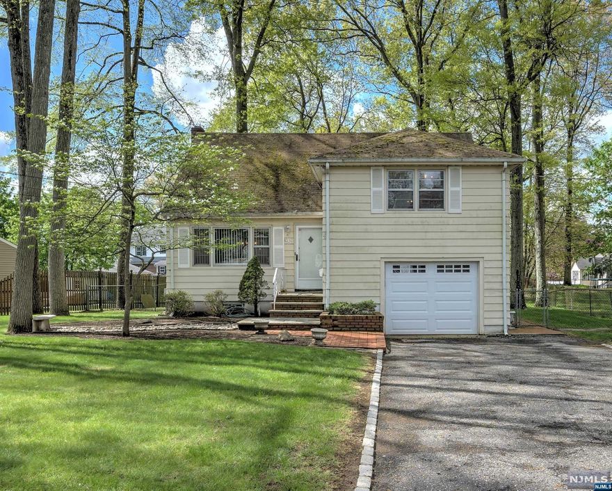 Spacious Tri-Level on Large Level Lot! This Sun Filled Home is Larger Than It Appears! Inviting Living Room and Dining Room with Wood flooring under Carpet. Living Room has Large Triple Window that Welcomes in the Sun! Updated Eat-in Kitchen with views of Serene Yard Space. Second Level with Two Nicely sized Bedrooms, Crisp Full Bath and Hall Linen Closet. Third Level with King Sized Primary Bedroom and En-Suite Full Bath. Primary Bedroom has abundant closets including walk-in and access to Attic Storage. Ground Level Den with Access to Rear Yard also has interior Access to home's 1 Car Garage with Bonus Storage. Light and Bright Finished Basement Family Room / Rec Room with both Laundry and Office Area. Central Air Conditioning. The Yard is a true oasis with large brick paver patio, lush lawn and is fully fenced! This is a must see home!