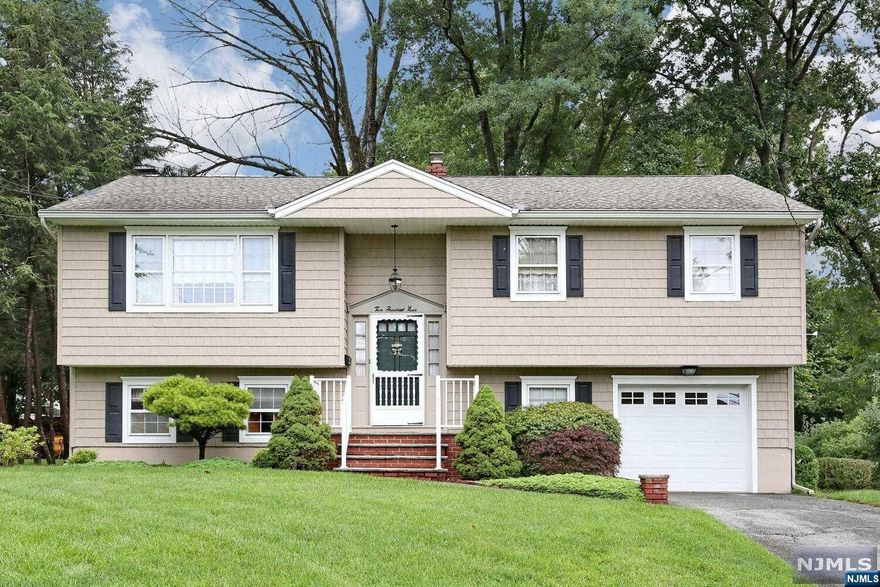 Welcome to this spacious 3 bed, 1.5 bath bi-level home in sought after Pompton Lakes. The open first floor flows from the living room to the dining room, perfect for entertaining. The kitchen offers ample space for cooking and dining. On this level, you'll find the primary bedroom, 2 additional bedrooms and a full bath. The ground floor impresses with a large family room and a wood-burning fireplace. Sliding glass doors lead to the patio for outdoor gatherings. The ground floor also includes a half bath, laundry room and garage entrance. This versatile home can accommodate a potential 4th bedroom. Many amenities including central air, hardwood floors and ample storage space. Outside, you'll find a lovely yard, perfect for outdoor activities or simply enjoying the beauty of nature. Conveniently located near schools, parks, shopping, and more. Schedule a showing today and discover the possibilities!