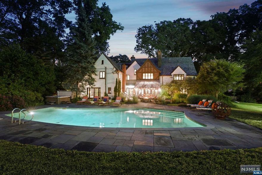 English Country Home in Estate neighborhood w/ Tennis/Pickle ball Court, Pool, Pavilion, Putting Green & Pond! Just 13 miles from NYC, the perfect home for entertaining & living. Living Room with architectural wows, stunning formal Dining/Billiards Room, and separate Office. Chef's eat-in Kitchen w/high end appliances, high end appliances, a center island & comfy Family Room. Inviting Patio with gas firepit, pond & view of the private property. 4 Bedrooms (plus laundry) on 2nd Floor including Primary Ensuite with Dressing Room & Princess Balcony. 3rd floor Movie Room. There's an additional Bedroom/Office up there as well. Host tastings in the wine room on the lower level. Charming outdoor pavilion has half bath. Close to vibrant Downtown with highly esteemed eateries, rooftop bar with NYC view, art museum, cinema, galleries, performance theatre. An exceptional opportunity to own a property of unparalleled beauty and grace.