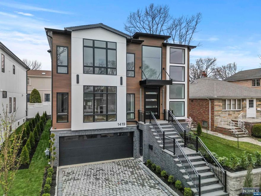 Indulge in luxury living with this brand-new masterpiece by a reputable builder on Fort Lee's sought-after street. A grand two-story foyer welcomes you with natural light and a 9-ft pivot door. Modern steps with glass railing lead to three bedrooms, each with en-suites and walk-in closets. Main suite boasts a spa-like bath, heated floors, and dual custom walk-in closets. Enjoy the convenience of a 14-ft laundry room with full cabinets. The open first floor layout includes a living room, dining room, bedroom/office with a full bath, and a custom chef's kitchen with high-end appliances, pantry, and an 8-ft island with a sink. The family room features a gas fireplace and built-in shelves. Step outside to a walkout paver patio and fenced yard. The ground floor offers a 2 car garage with EV Compatible Outlet, an 6 person movie theater, a spacious rec room with a wet bar, and a full bathroom. Elevate your lifestyle in this meticulously designed and thoughtfully crafted residences!