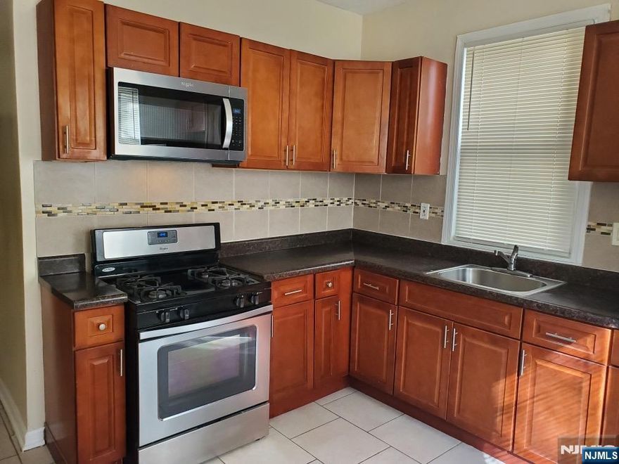 This meticulously maintained first-floor residence offers the perfect blend of urban convenience and modern comfort in the heart of Newark's Upper Clinton Hill. This spacious three-bedroom unit features an open, sun-drenched living area that flows into a dedicated dining space and a kitchen with ample cabinetry. All three bedrooms are generously sized with large windows and sufficient closet space, with the primary bedroom easily accommodating a full bedroom set. A commuter's dream, this home is located steps from NJ Transit bus lines with direct links to Newark Penn Station, the PATH, and Amtrak, while offering easy access to I-78 and the Garden State Parkway. Residents will enjoy being walking distance to local schools, West Side Park, and various neighborhood shopping and dining options. This unit represents a premier opportunity for high-quality living.